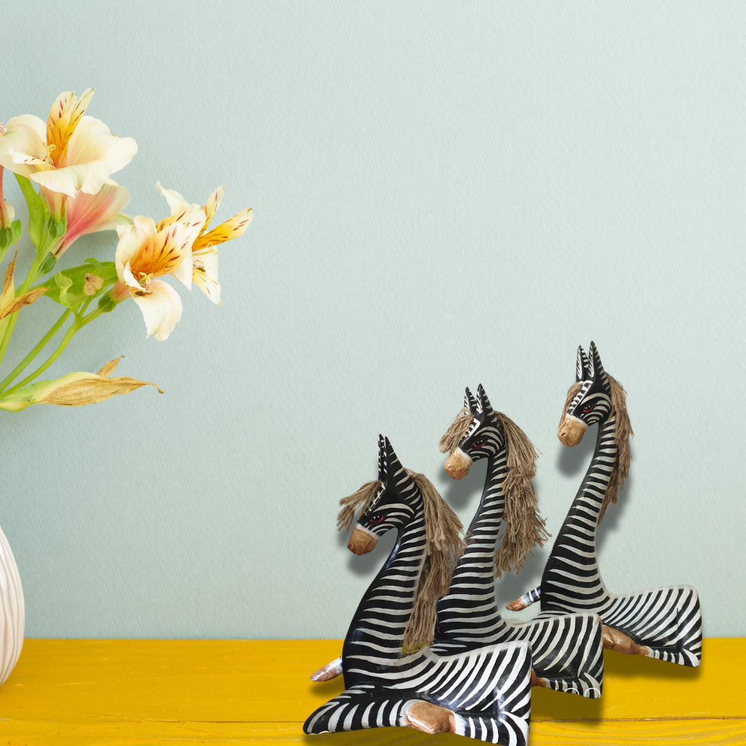 A set of 3 Zebra statues set on a vibrate back gorund