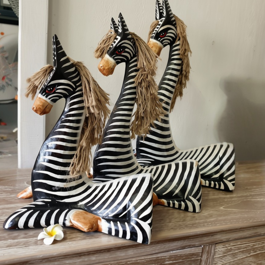 Set of 3 black carved animals on timber sideboard, raw photo