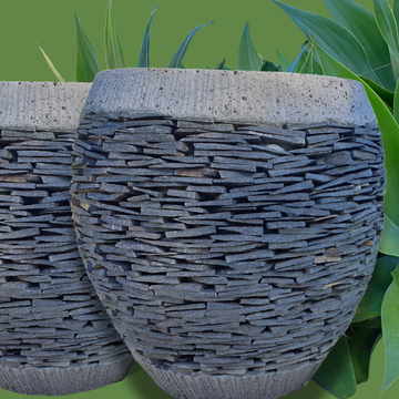 Decorative stone planters with a textured surface on a green background