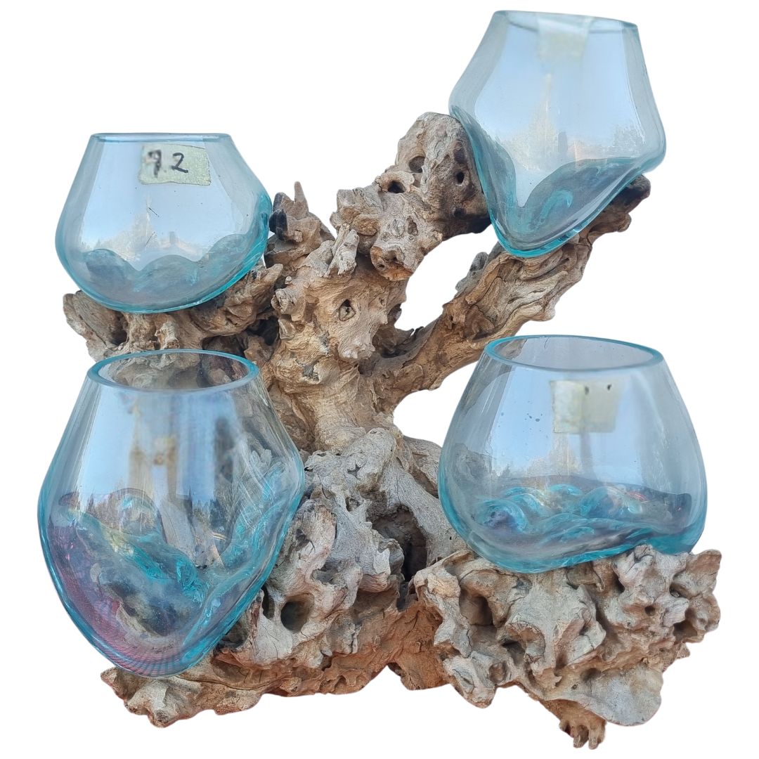 Decorative holder with blue glass cups on a natural wood and coral base
