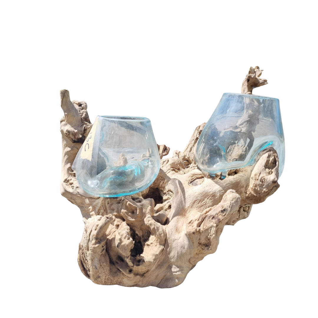 Two blue glass candle holders on a natural wood base against a white background