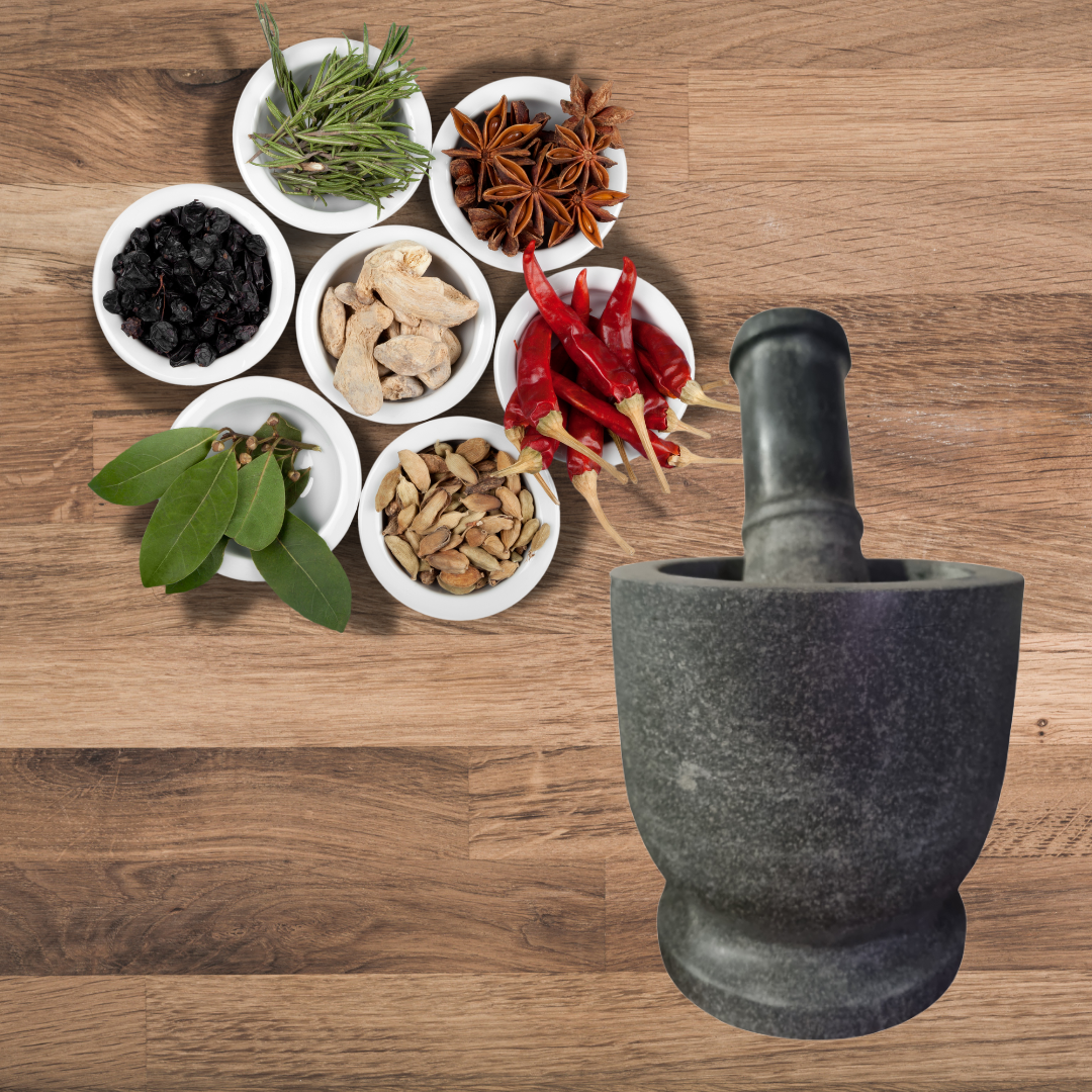 Mortar and pestle with various spices on a wooden surface
