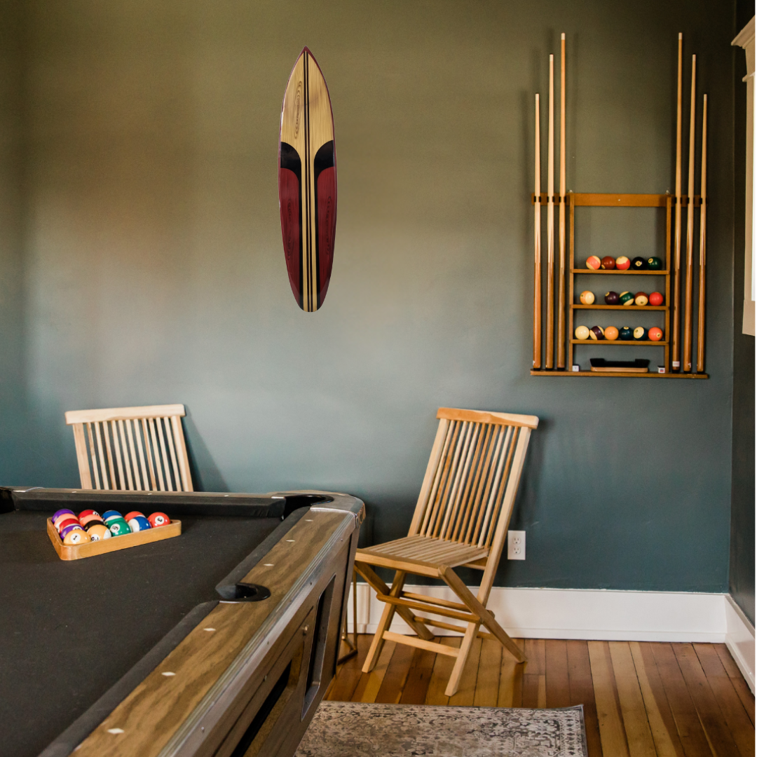 Pool table with chairs and billiard balls against a green wall