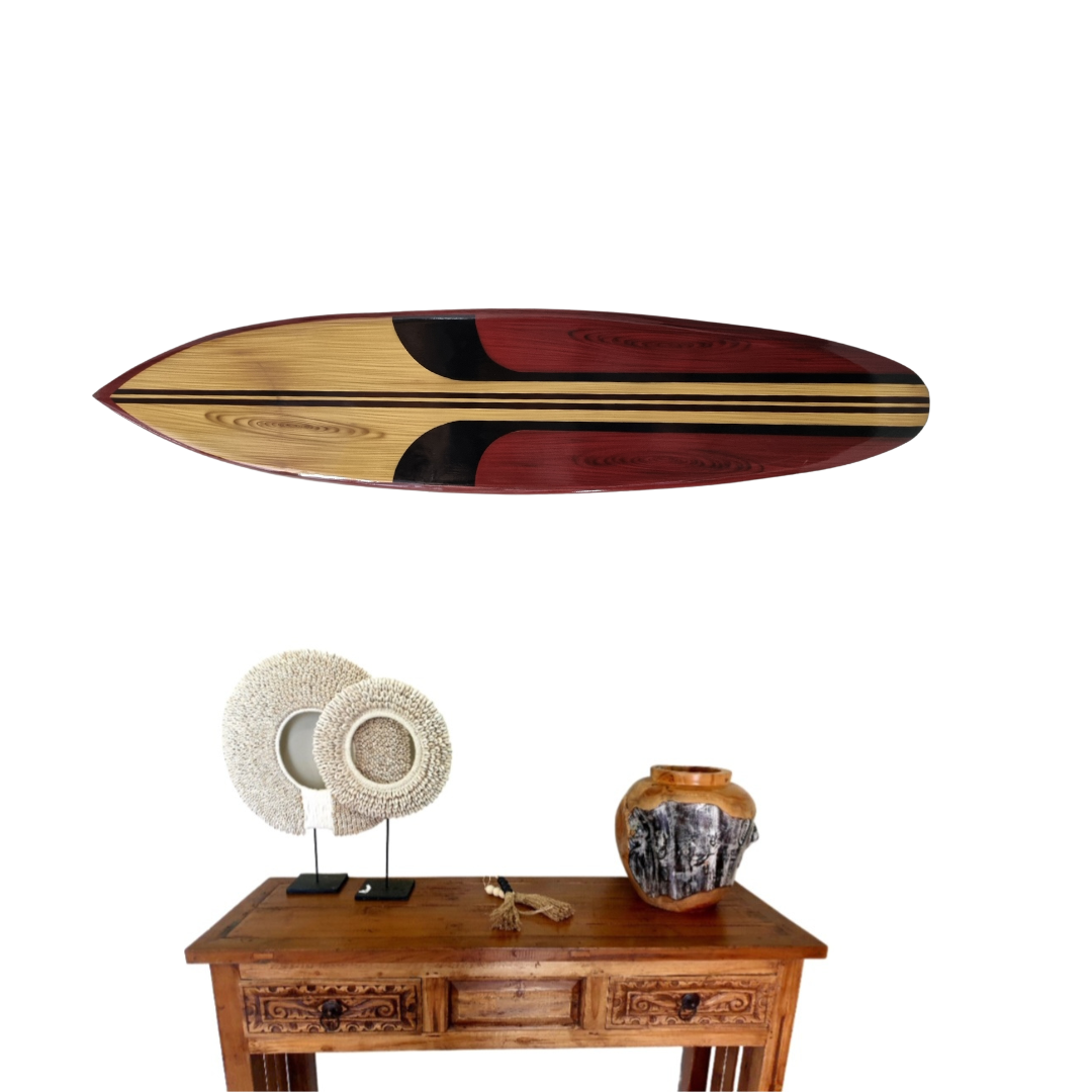 Wooden surfboard with decorative items on a wooden table against a white background