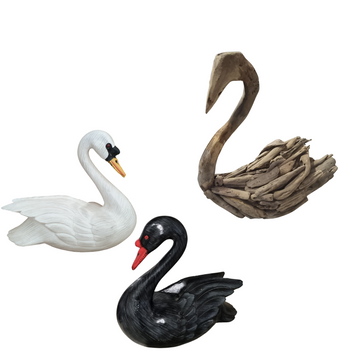 White and black timber swans alongside natural driftwood swan decor on a white background
