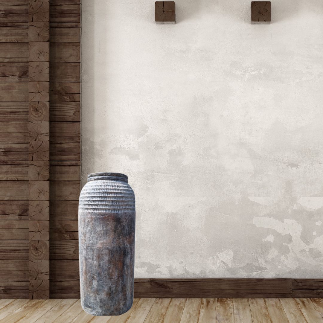 Tall rustic textured floor vase styled beside a white sofa and reclaimed timber barn door in a farmhouse living room | Azure Decor