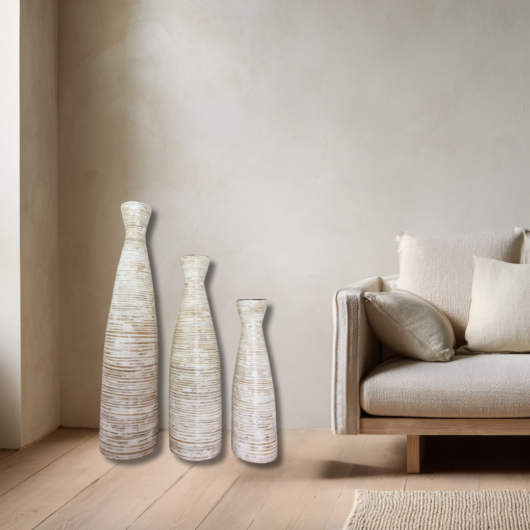 Three decorative vases of different sizes in a living room setting.