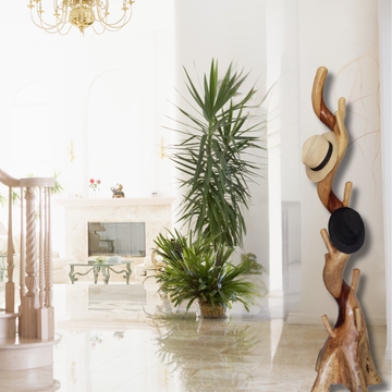 Decorative wooden coat rack with hats in a stylish interior setting.