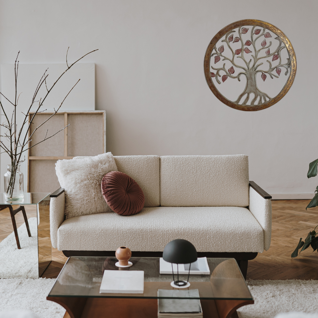 Modern living room with a beige sofa, decorative pillows, and a wall art piece.