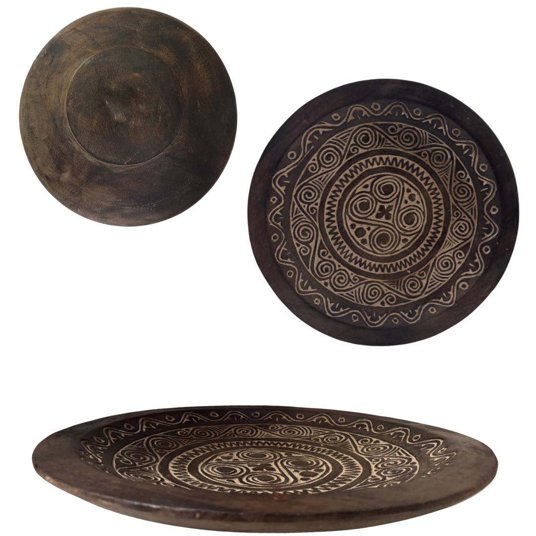 Three wooden plates with intricate carvings on a white background