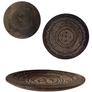Three wooden plates with intricate carvings on a white background