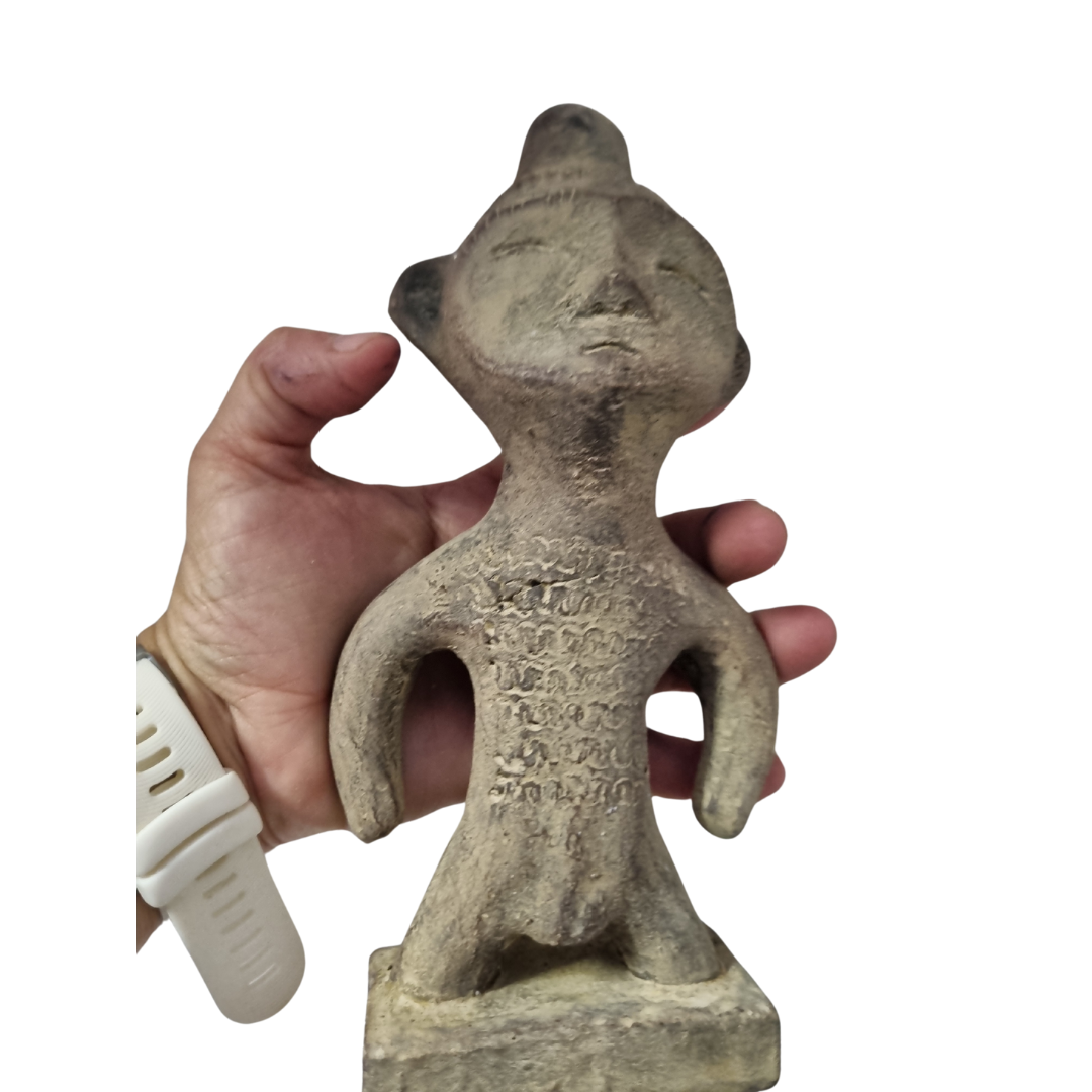 Tribal stone statue inspired by ancient Sulawesi figures display held by hand to show size