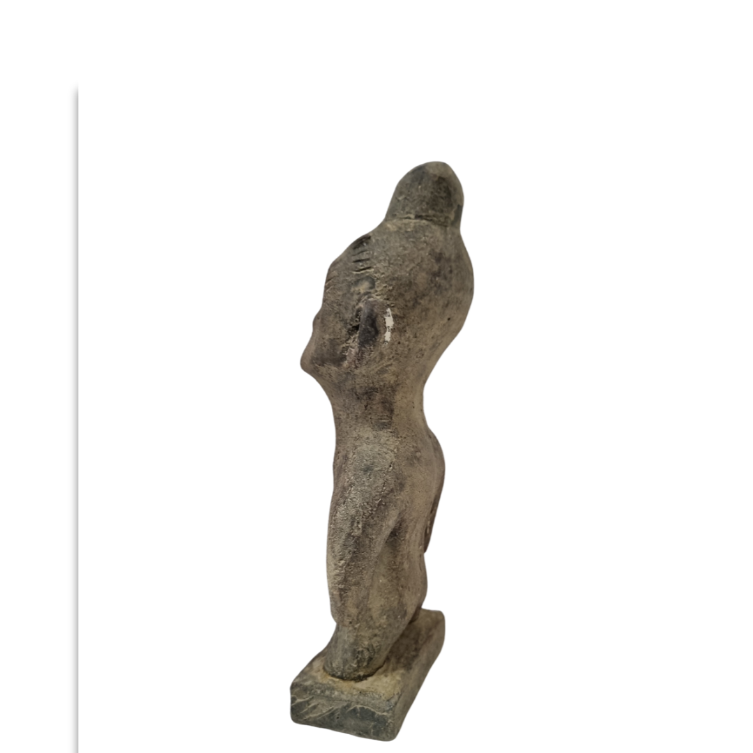 Tribal stone statue inspired by ancient Sulawesi figures displayed on sideview on white wall