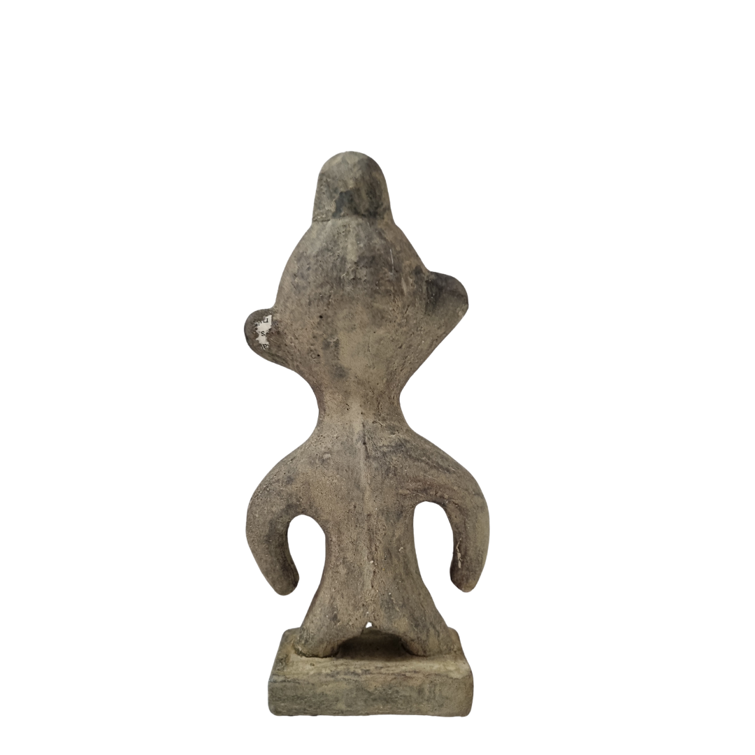 backviewTribal stone statue inspired by ancient Sulawesi figures white wall