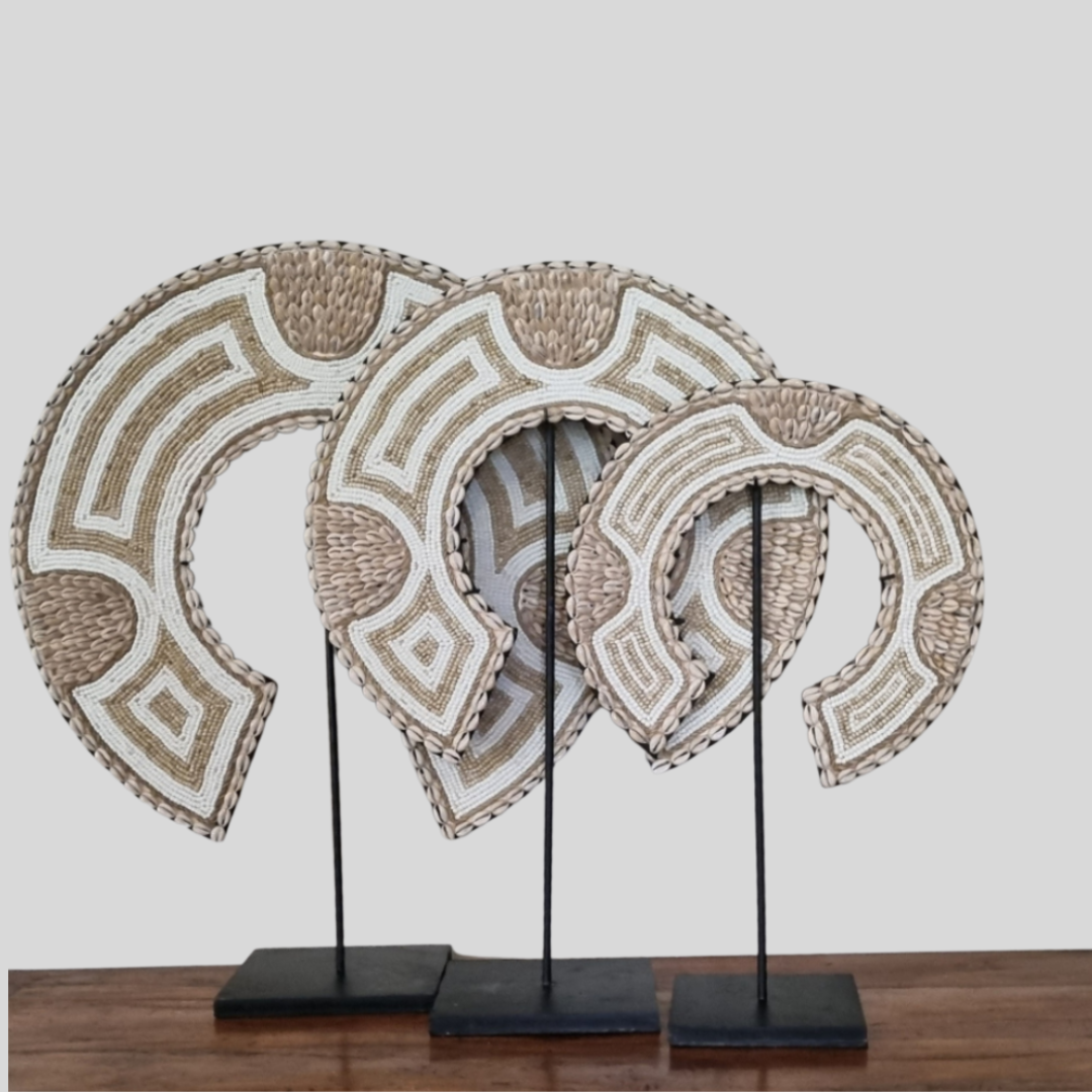 Decorative wall art with geometric patterns on a stand against a white background