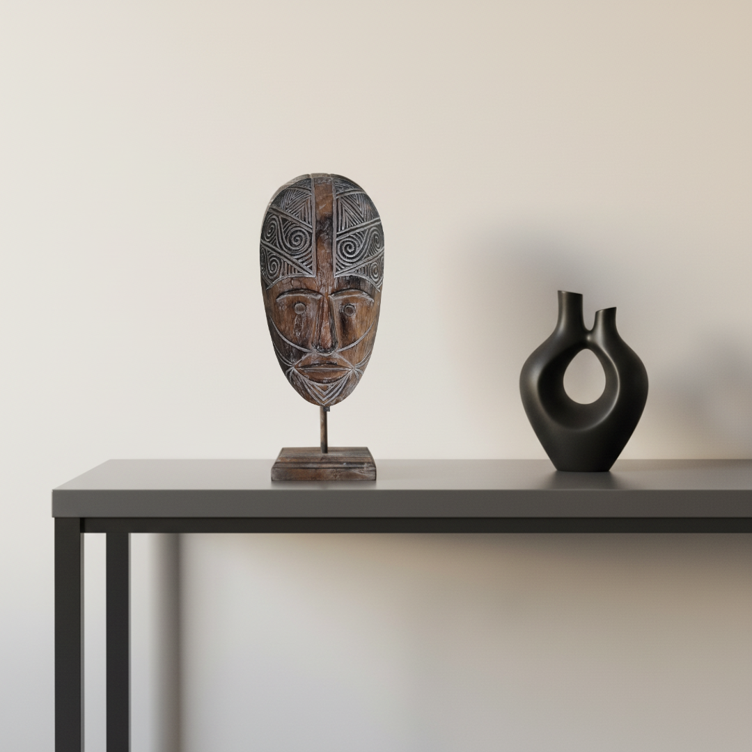 Brown carved décor displayedon a hallway table with a abstract black vase.