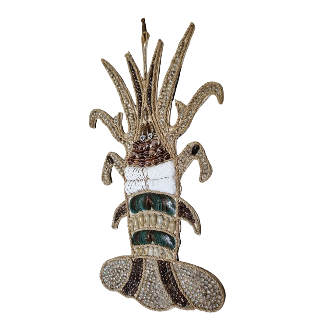 Stylish Crayfish-lobster wall art made from shells and jute rope on a white back wall 