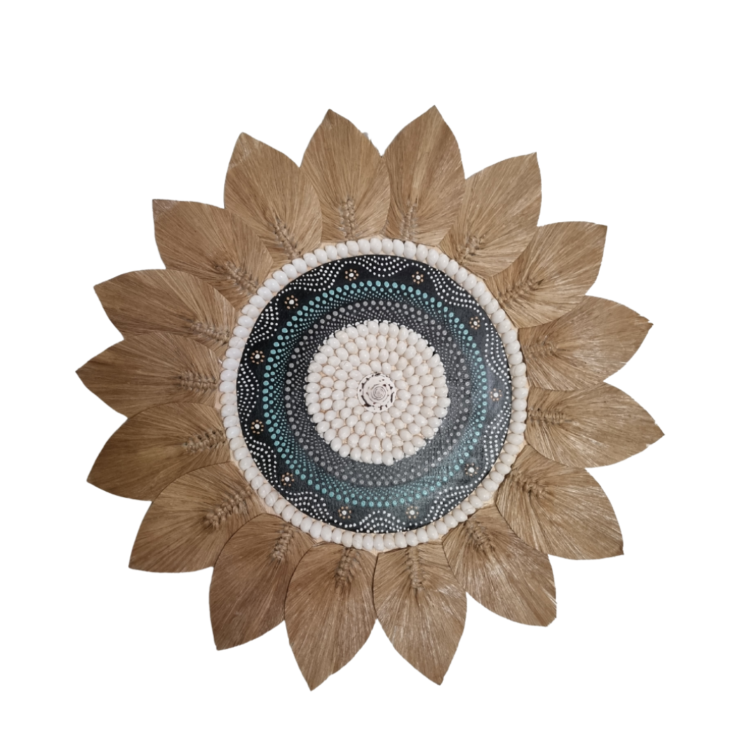 Decorative sunflower-shaped wall art piece with a shell pattern on a white background