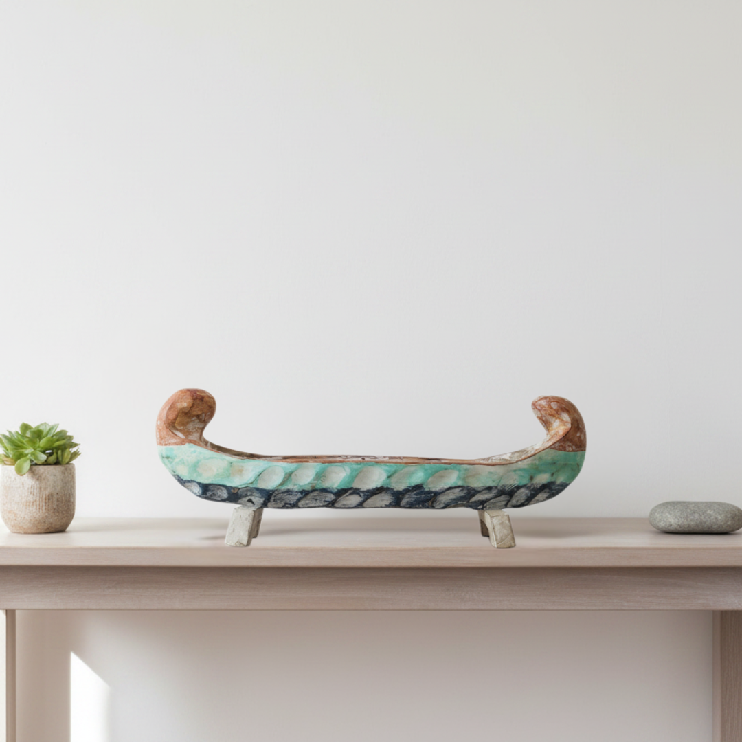 Tropical Teak Canoe Bowl with turquoise, brown and white finish on two rectangular legs styled on a hallway console table in a modern coastal Australian home with succulent and river stone