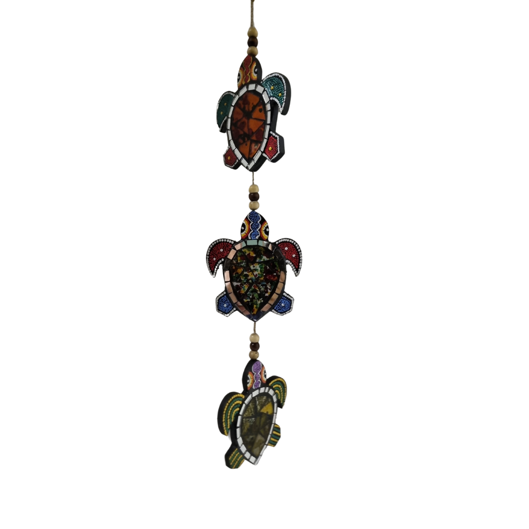 Decorative turtle-shaped ornament with beads on a white background