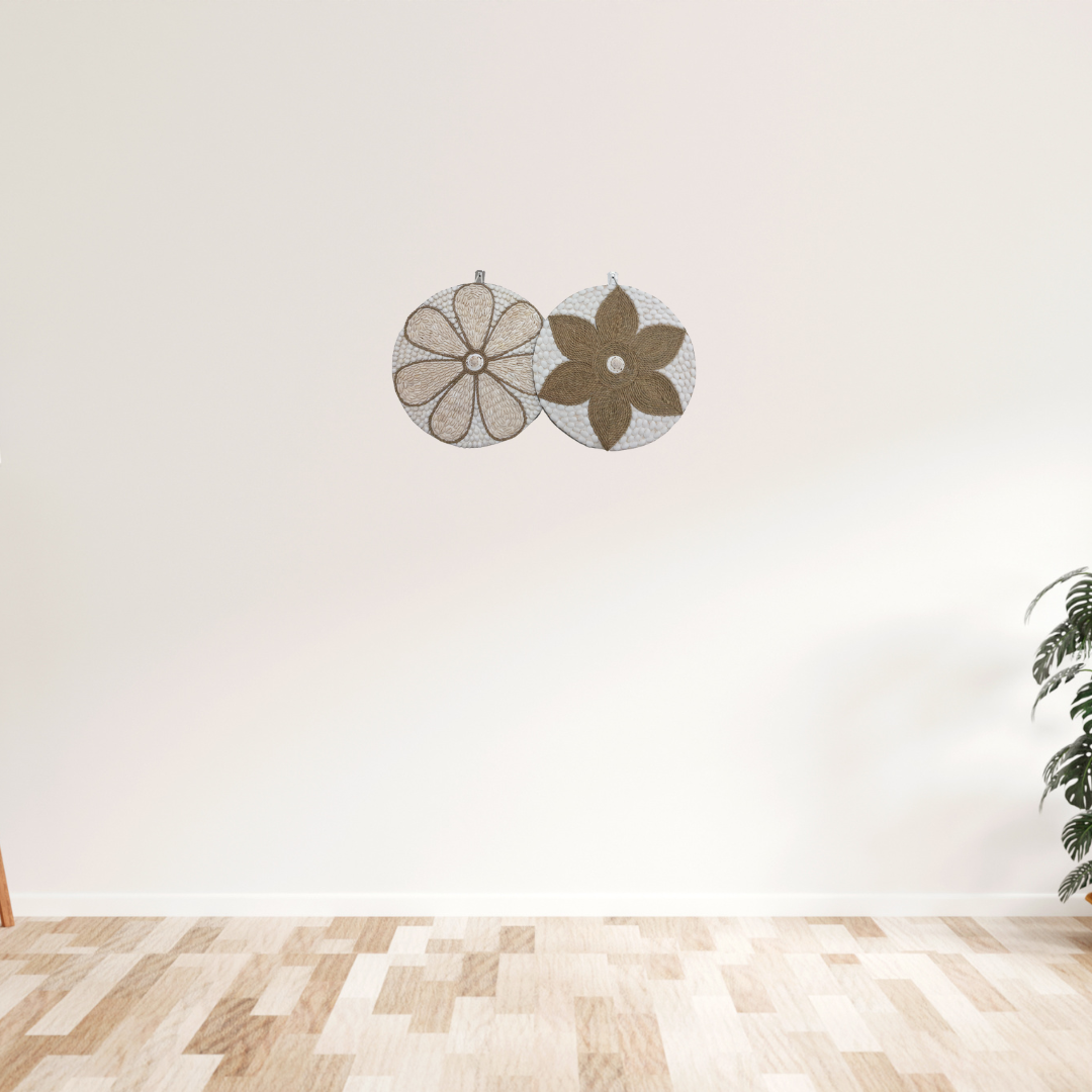 Two round wall decorations, one with a beige and white floral pattern and the other with a brown and white geometric pattern, both featuring a central shell accent.