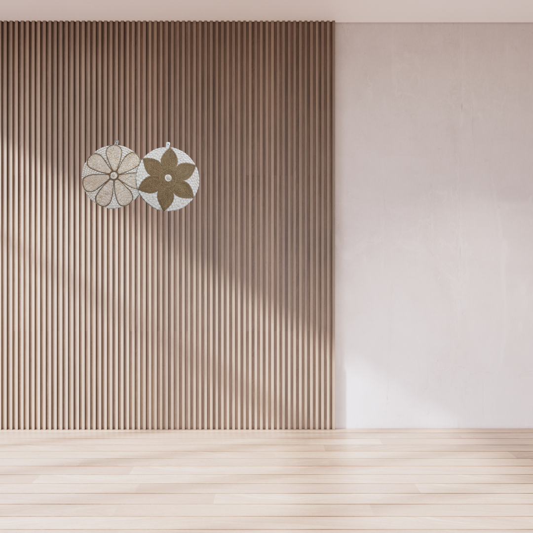 Two round wall decorations, one with a beige and white floral pattern and the other with a brown and white geometric pattern, both featuring a central shell accent.