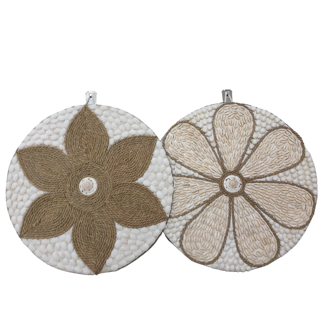 Two round wall decorations, one with a beige and white floral pattern and the other with a brown and white geometric pattern, both featuring a central shell accent.