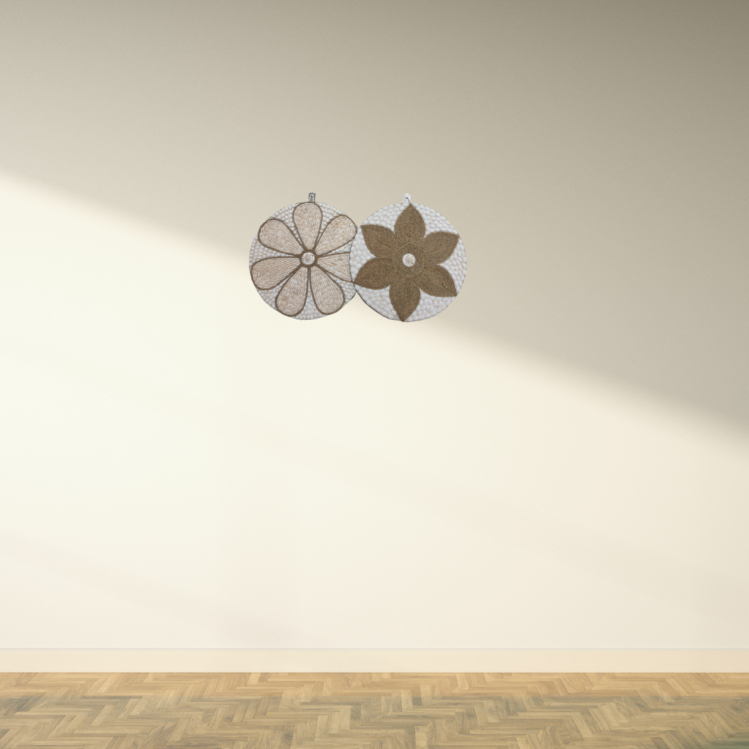 Two round wall decorations, one with a beige and white floral pattern and the other with a brown and white geometric pattern, both featuring a central shell accent.