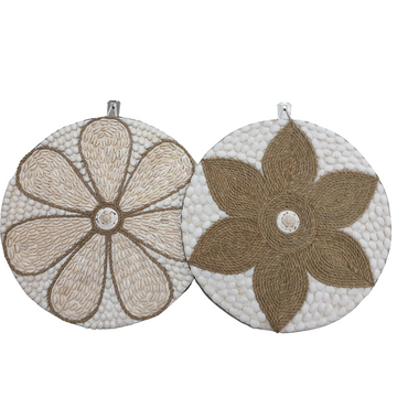 Two round wall decorations, one with a beige and white floral pattern and the other with a brown and white geometric pattern, both featuring a central shell accent.