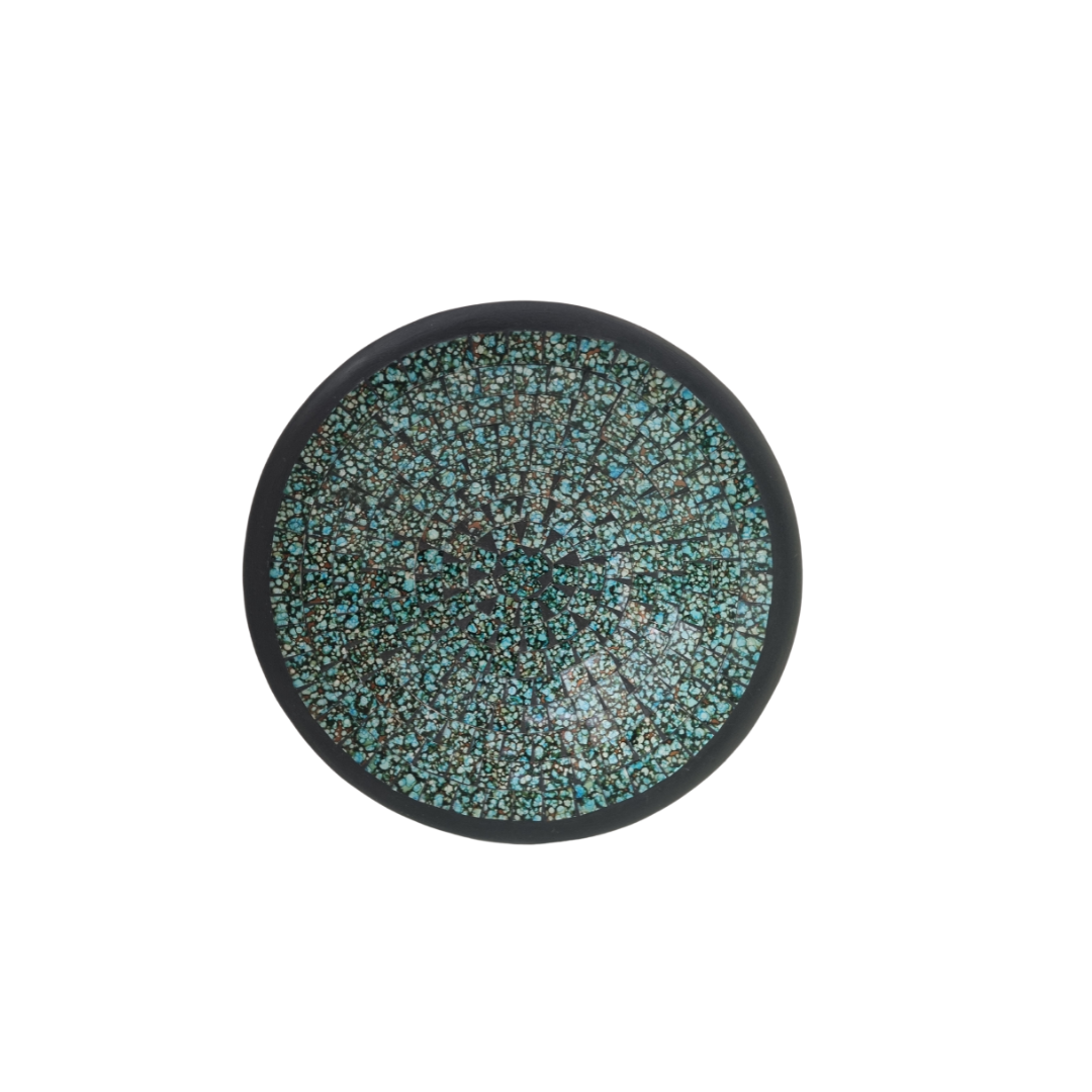 A decorative bowl with a tile design, displayed on a white background.