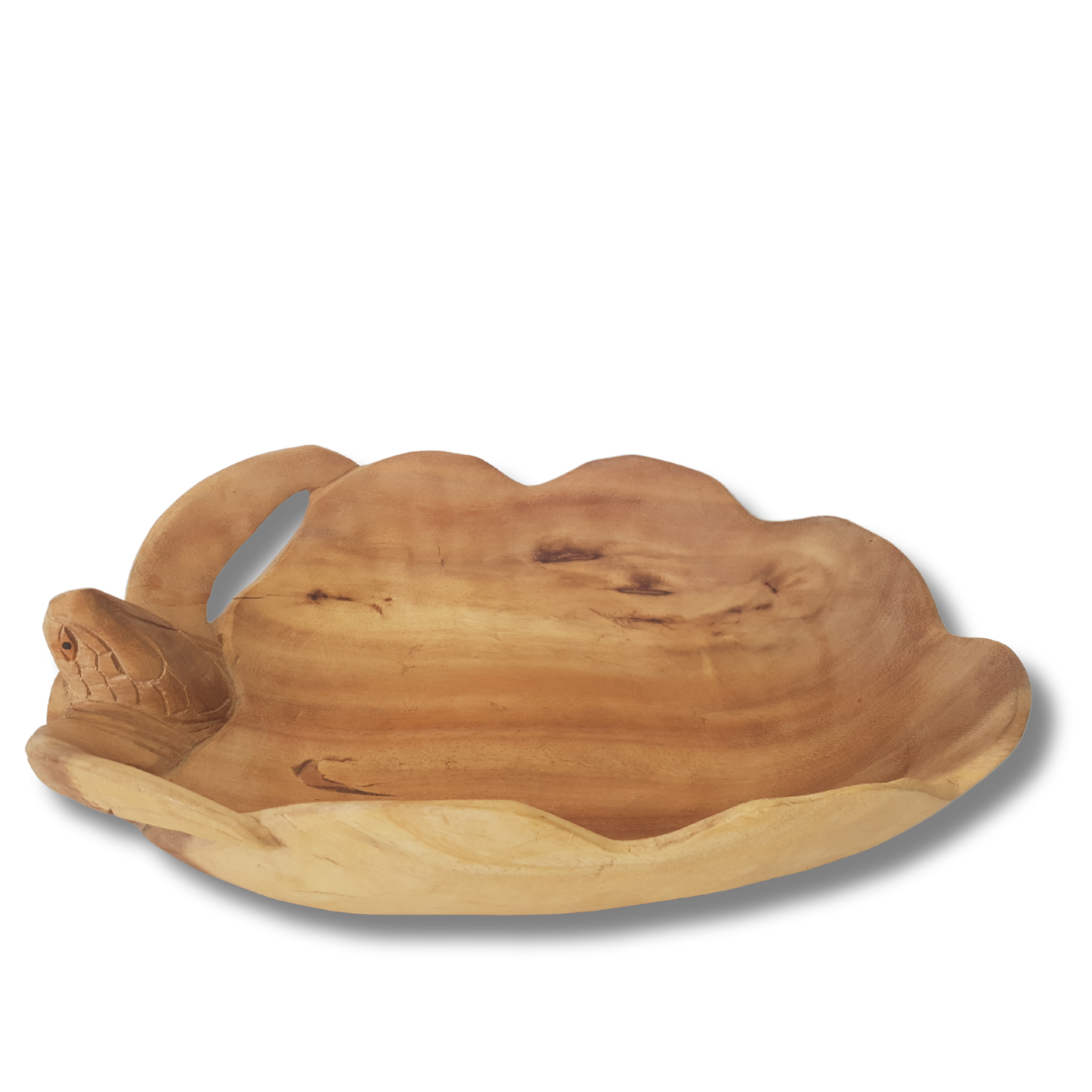 scalloped wavy rim and carved turtle head detail on the side, viewed from a low angle on a white background