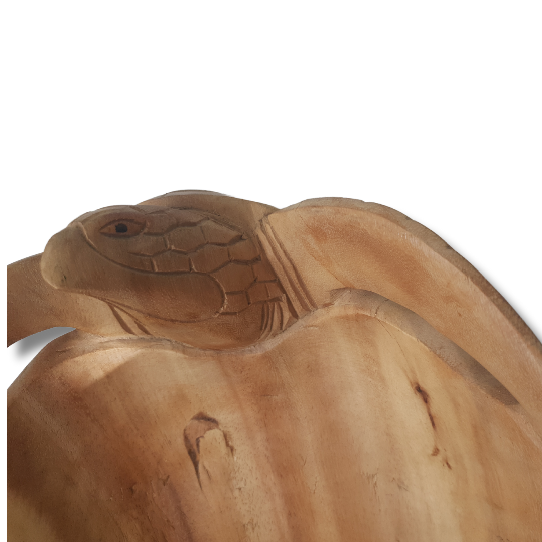 Close-up of a  with detailed scale texture and eye carving on a wooden bowl