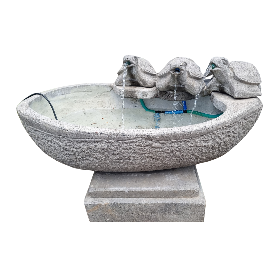 Stone-like decorative water fountain with glass bowl on a white background