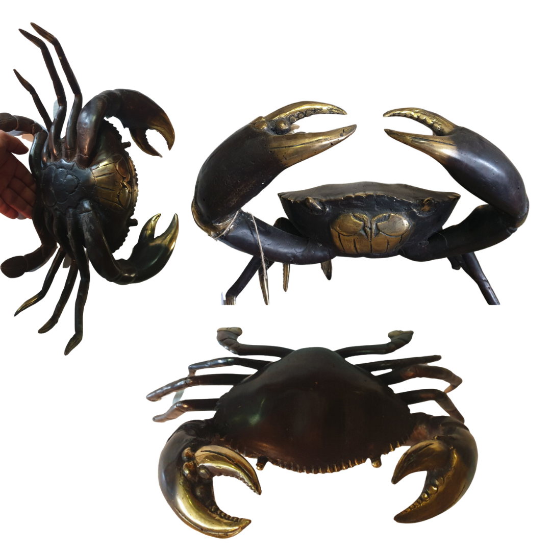 Three crab-shaped figurines with gold accents on a white background