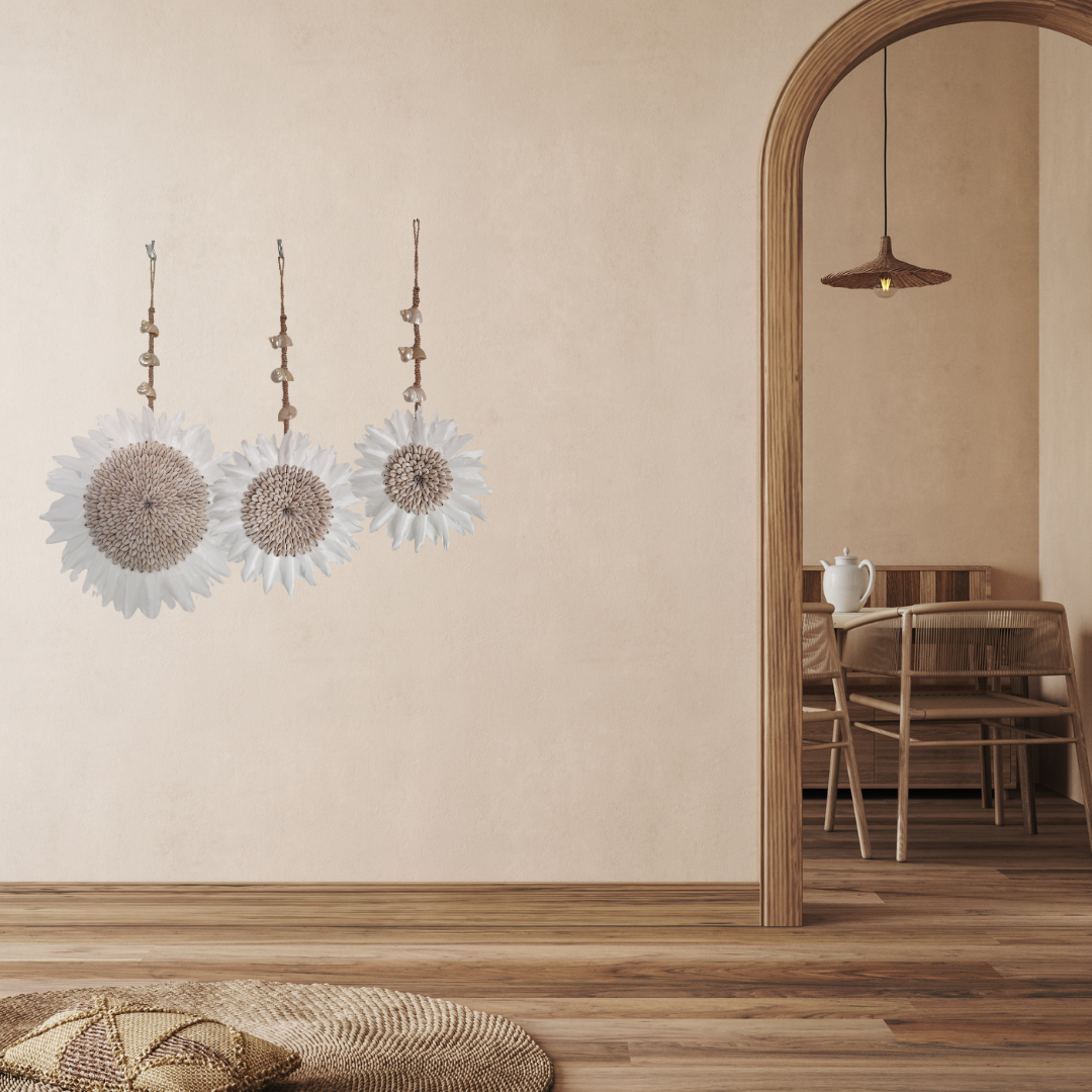 Decorative wall art with floral designs in a room with wooden flooring and furniture.