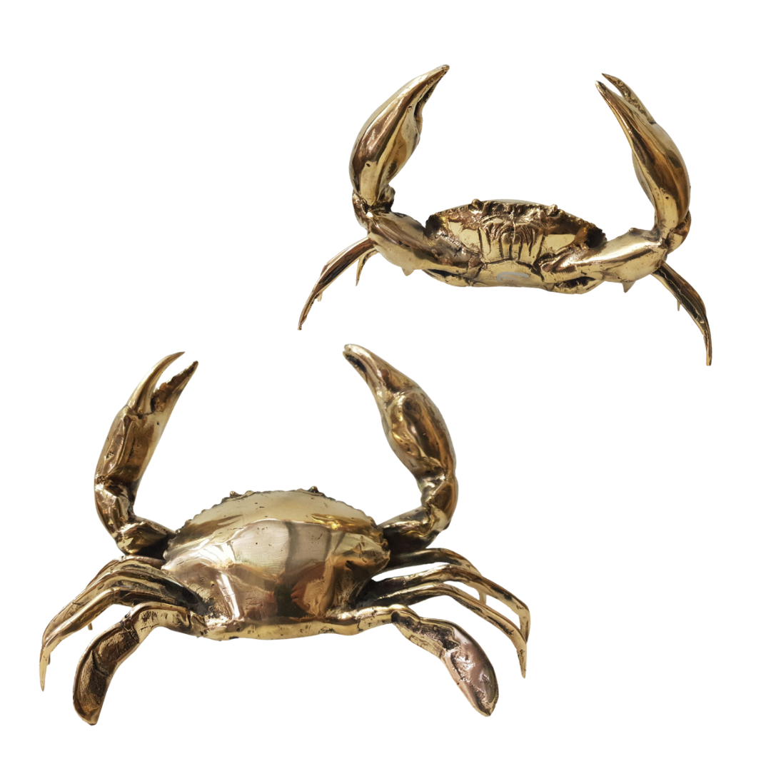 Two gold crab figurines on a white background