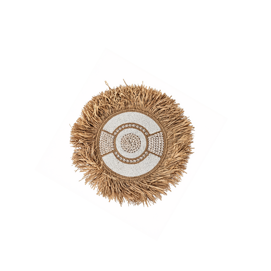 Small 40 cm circular boho style wall art made with seagrass, beads and shells in natural beige and white, against a white background.