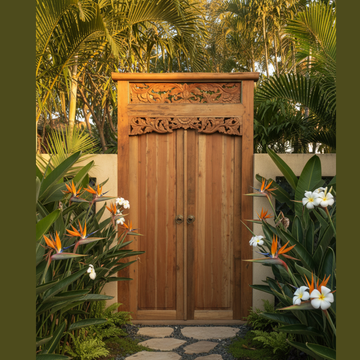 Balinese reclaimed timber door set as a garden entryway with stone stepping stone pathway and lush tropical plantings either side
