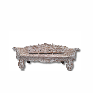 Balinese hand-carved whitewashed reclaimed teak day bed front view showing intricate floral and scroll carved backrest panels, ornate rolled arms, heavily carved apron and cabriole legs – handcrafted furniture by Azure Decor


