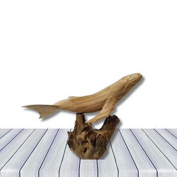 Wooden sculpture of a whale on a white background