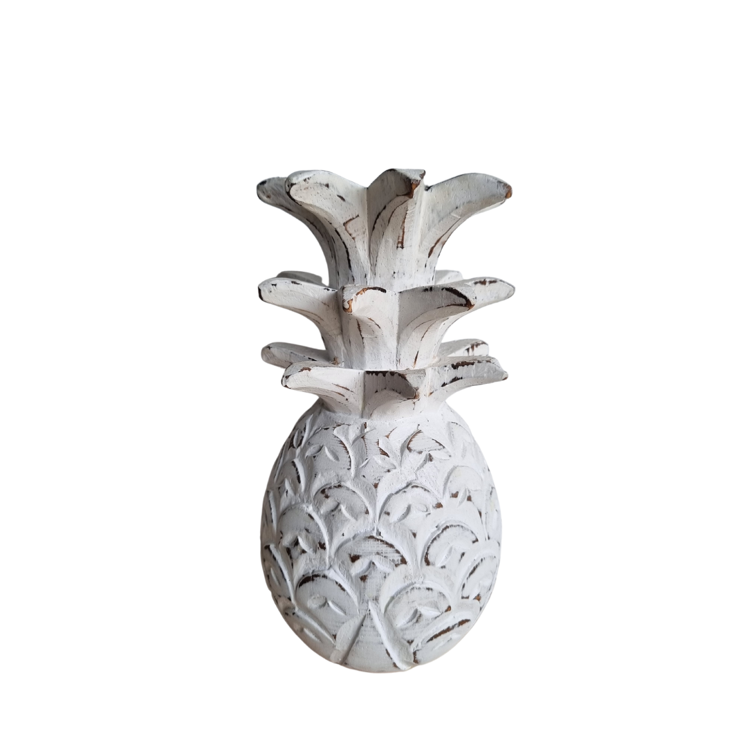 Decorative white pineapple sculpture on a white background