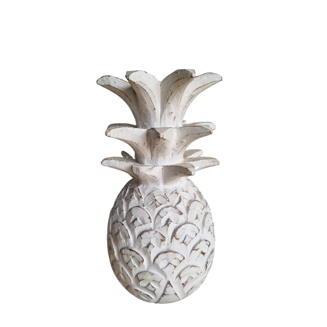 Decorative pineapple sculpture with intricate patterns on a white background
