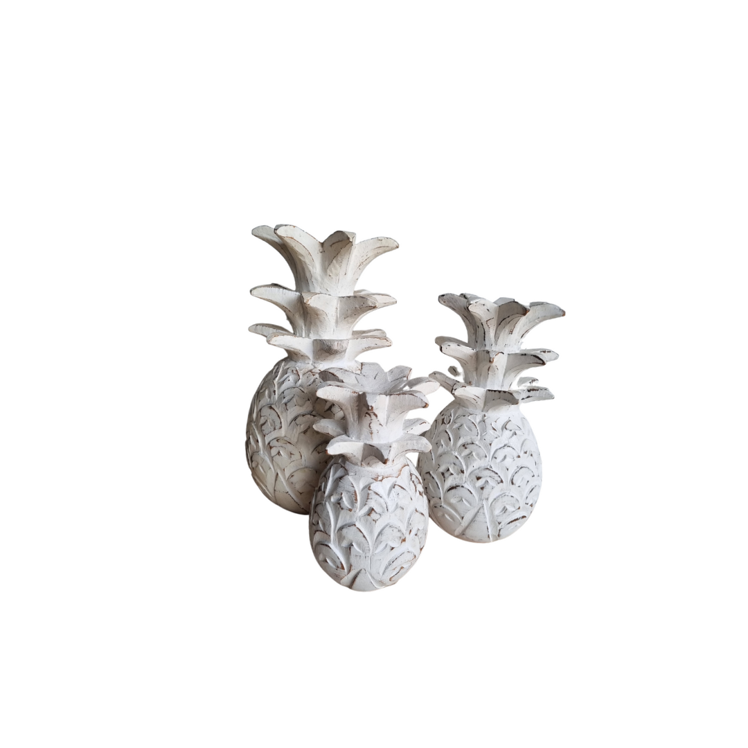 Decorative pineapple wall sconces on a white background