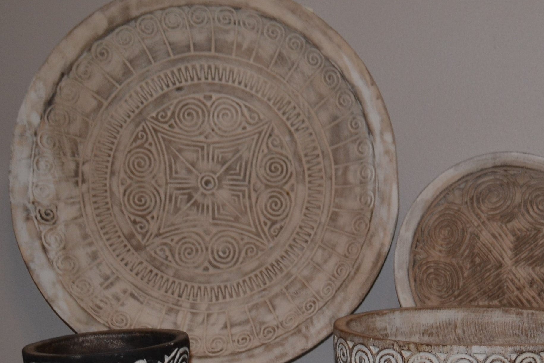 Decorative ceramic plates with intricate patterns on a neutral background
