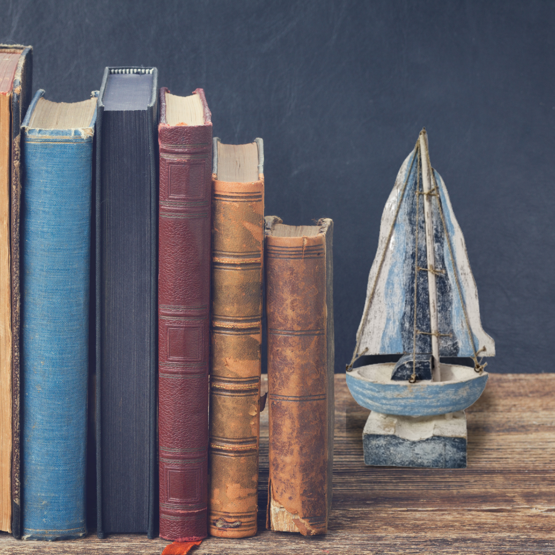 shelf with books and sail boat