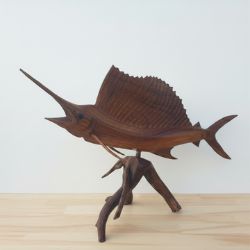 Fish artwork on natural driftwood base, warm brown tones, front-right angle