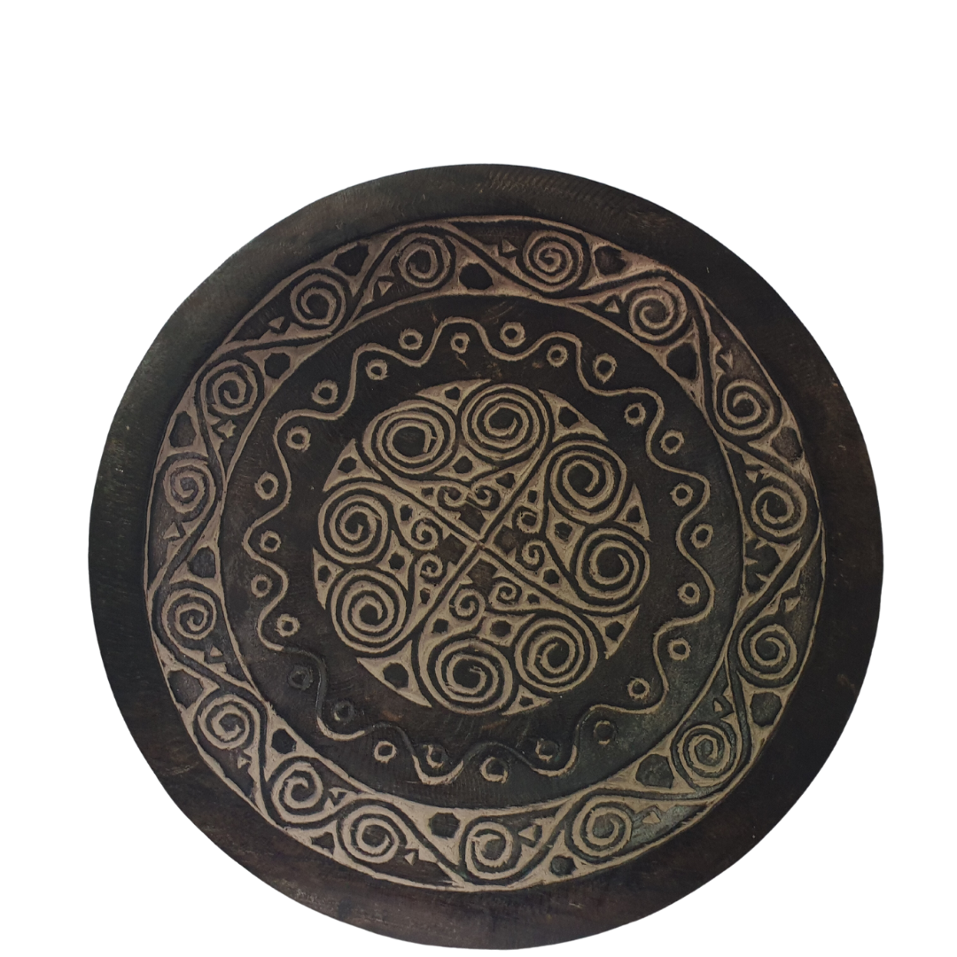 rustic style tray with tribal markings with a white back wall 