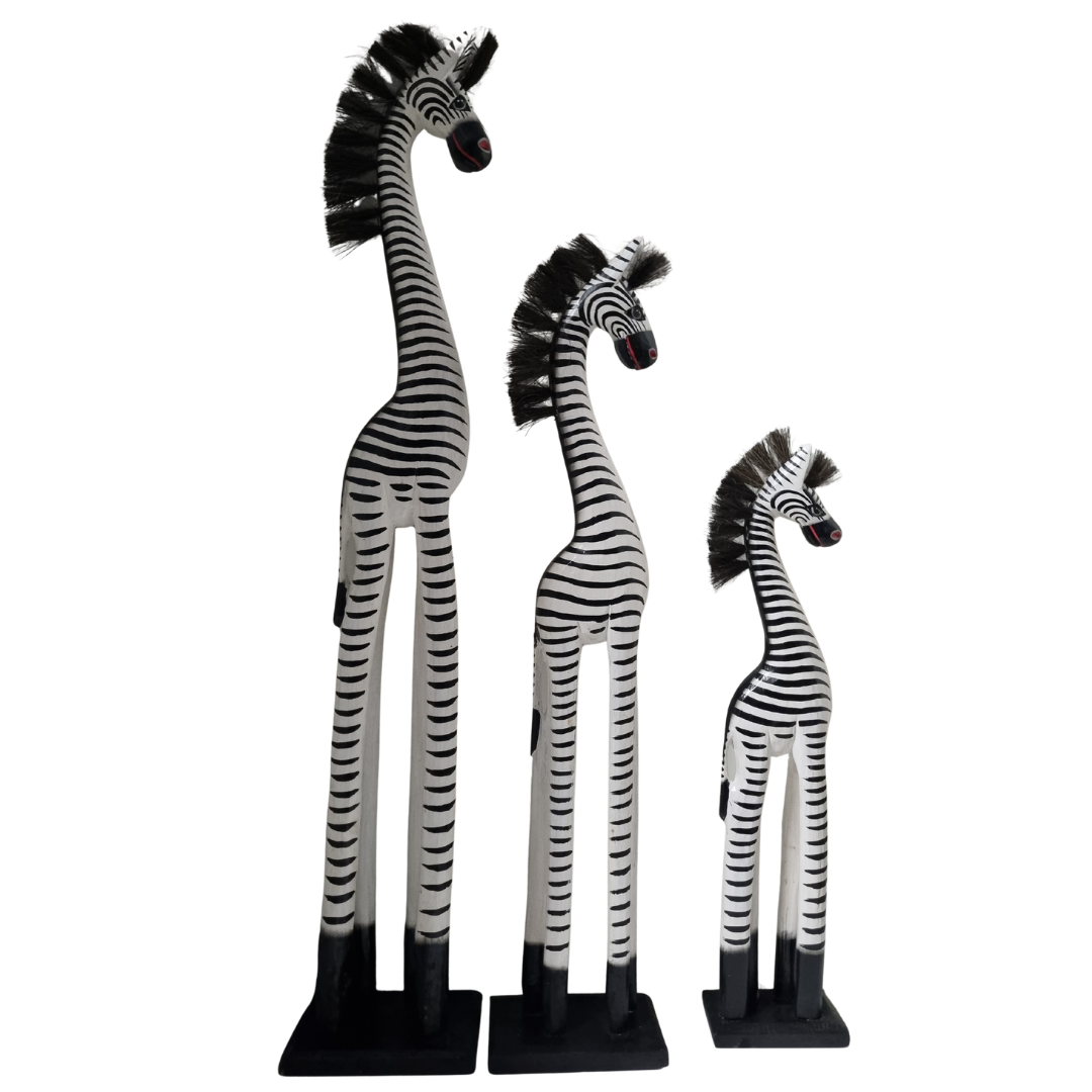 Three zebra figurines of different heights on a white background