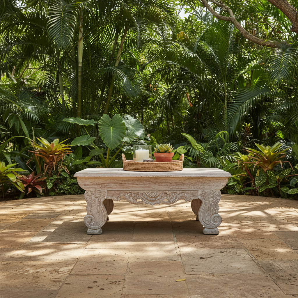 Authentic Balinese teak coffee table styled on a stone patio surrounded by tropical garden greenery and dappled sunlight