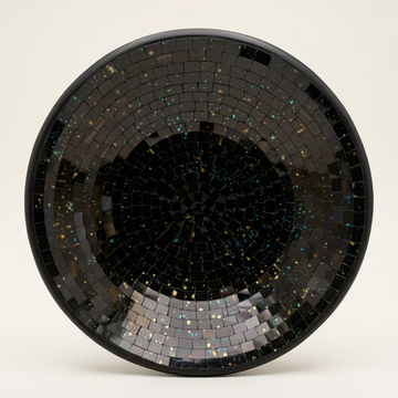 Black mosaic bowl with a dark rim and subtle iridescent flecks, displayed upright against a white background.